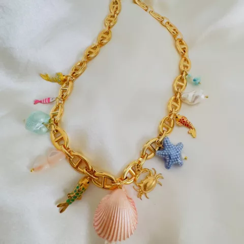 Necklace with stainless steel chain, freshwater pearls, semi-precious stones, and natural shell accents